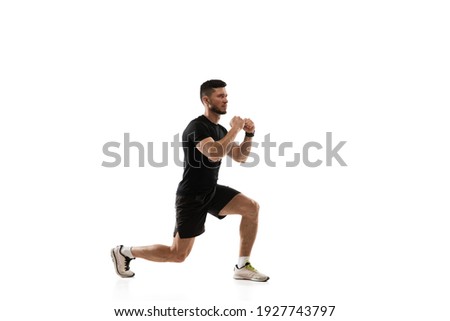 Squats. Caucasian professional sportsman training isolated on white studio background. Muscular, sportive man practicing. Copyspace. Concept of action, motion, youth, healthy lifestyle. Royalty-Free Stock Photo #1927743797