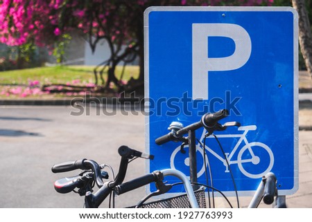 Blue parking sign for only bicycle in the botanic garden park in the middle of urban city, during car free day event for save global warming, eco life style