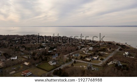 An aerial view of the eastern end of Orient Point on Long Island, New York. Taken during a golden sunset with cloudy skies. The waters were calm and the area was empty, quiet and peaceful.