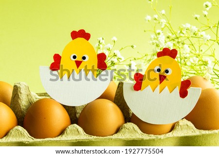 Easter. Easter decorations. Eggs and chicken on a light background. Blank for a greeting card. Easter decor. Copy space.