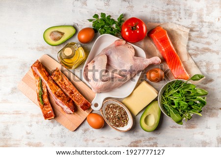 A set of different products for the keto diet. Chicken, meat, eggs, vegetables, avocado, cheese, fish. Low carbs diet concept. High quality photo