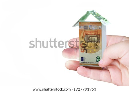 Abstract photo in hand of man with abstract house from euro bills isolated on white background