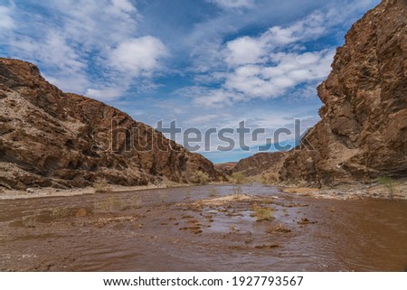 Gaub river in Namibia with much water after heavy rainfalls, Namib-Naukluft National Park, background blue sky