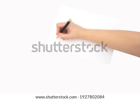 hand writes with a pen on white blank paper on a white background