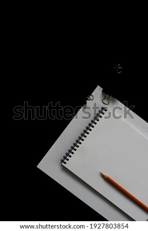 Flatlay of Office Stationery, Blank Notebook and Checklists on Black Background. Minimal Design Mockup with Copy Space.