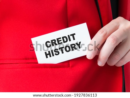 businessman holding a card with text credit history