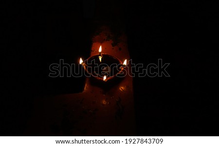 A beautiful earthen 'diya' or 'pradeep' burning on Dewali night. The picture is taken in low light conditions. 