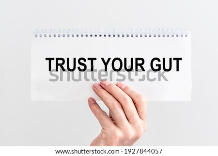 Trust your gut inscription. Follow instincts concept. Royalty-Free Stock Photo #1927844057