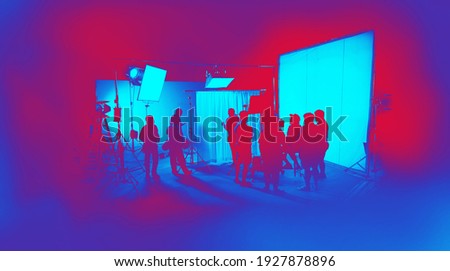Silhouette images of video production behind the scenes. making of TV commercial movie that film crew team lightman and cameraman working together with film director in studio. film production concept