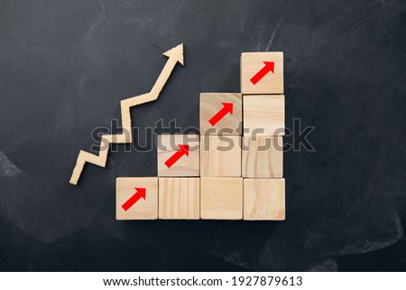 Wooden cubes with arrows. Business concept on dark background