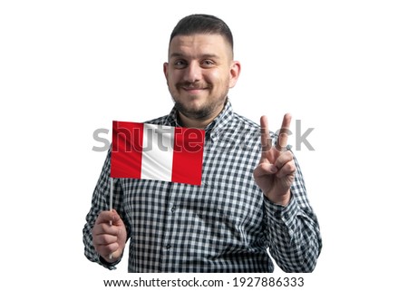 White guy holding a flag of Peru and shows two fingers isolated on a white background.