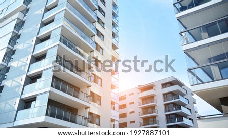 Apartment residential house and home facade architecture and outdoor facilities. Blue sky on the background. Sunlight in sunrise. Royalty-Free Stock Photo #1927887101