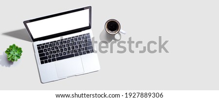 Laptop computer with a coffee cup from above Royalty-Free Stock Photo #1927889306