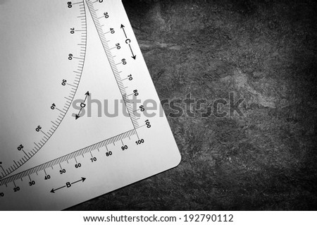 Old protractor style measuring device with algebraic symbols and graph measurements