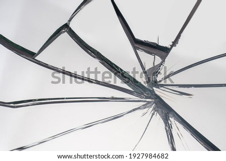 Broken glass with cracks. The mirror shattered into fragments. Cracks on white glass. The symbol of no luck and problems. Life cracked. Royalty-Free Stock Photo #1927984682