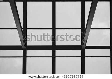 Cantilever Steel and Glass Roof.  Black and white  upward view of cantilever construction.