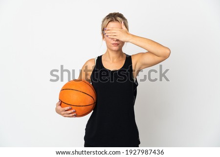 Young Russian woman playing basketball isolated on white background covering eyes by hands. Do not want to see something