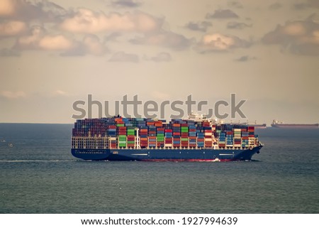 Ship with many containers heading to the open sea.
 Royalty-Free Stock Photo #1927994639