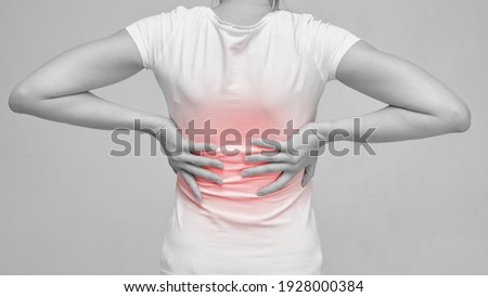 The person is massaging the back because of the feeling of pain from sciatica and neurology Royalty-Free Stock Photo #1928000384