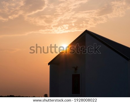 The silhouette of the house at sunrise or sunset, beautiful in the countryside