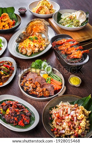 kind of authentic indonesian food : Sate, Fried Gurame Fish, Nasi goreng, Kecombrang, Bistik Lidah Sapi, and more Royalty-Free Stock Photo #1928015468