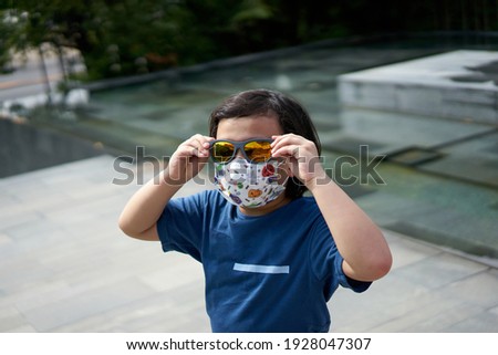 Asian boy wear mask outside for protect COVID-19                               