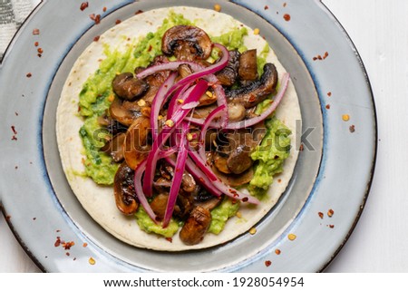 Mushroom and guacamole tacos on white background. Traditional mexican food