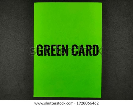 Selective focus.Word GREEN CARD on green paper card with black background.