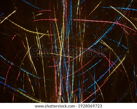 Abstract blurred background of bright colorful Christmas lights. Ideas for creativity and text. Color play of neon light bulbs. Festive background. Holiday card. 