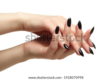 Female hands with black nails manicure.  Isolated on white background.