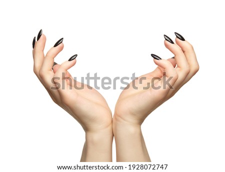 Female hands with black nails manicure.  Isolated on white background.