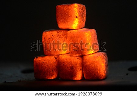 Fire burning from coconut charcoal briquette for business production