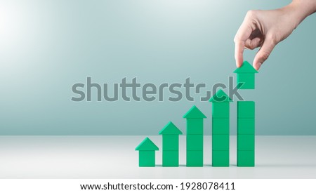 Hand arranging green block stacking as step stair with arrow up.concept of business growth success process,career path,target,planning and development for corporation.