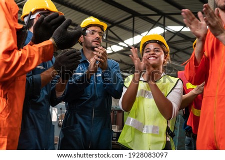 Skillful worker celebrate success in the factory . Industrial people and manufacturing labor concept .