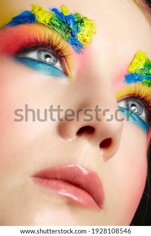 Close-up of teenager girl portrait with unusual face art make-up. Paint on brows.