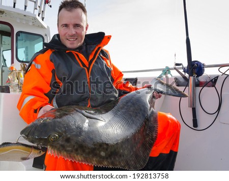 Man with huge halibut fishing trophy