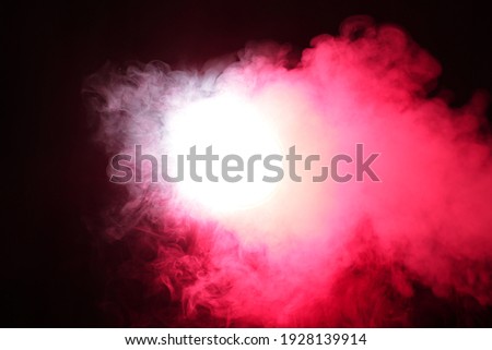 Smoke in red light on black background in darkness