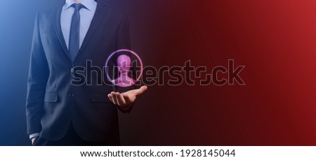 An empty workpiece. A businessman in a suit on a black background holds his hands protective gesture. A gesture of care and patronage