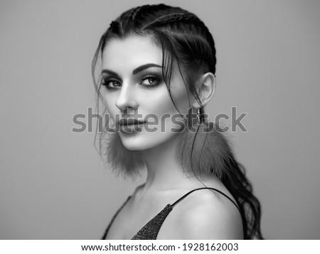 Brunette girl with perfect makeup. Beautiful model woman with curly hairstyle. Care and beauty hair products. Lady with braided hair. Model with jewelry. Black and white photo