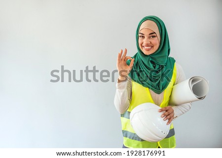 Portrait of Arab architects. Muslim woman architect isolated in gray background. Muslim female architect  looking at camera. Architect Young Muslim women at work. 