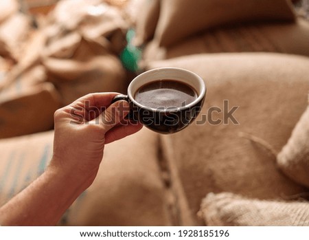 a cup of delicious fresh roasted coffee in coffee warehouse Royalty-Free Stock Photo #1928185196