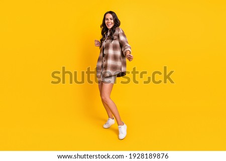 Photo of dreamy lady dance having fun wear checkered jacket mini skirt shoes isolated yellow color background