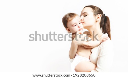 Mother care. Young mother embracing her cute baby on white background with empty space