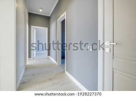 long white empty corridor in interior of entrance hall of modern apartments, office or clinic Royalty-Free Stock Photo #1928227370