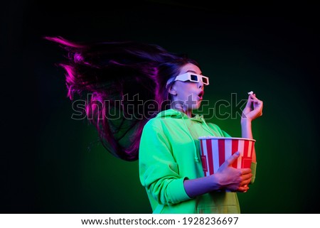 Photo of impressed charming young lady wear green sweater watching movie eating popcorn isolated colored bright shine background