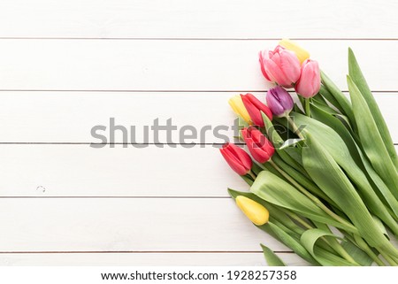 Spring concept. Tulip bouquet on black wooden background with copy space