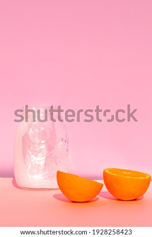 Close-up of halves oranges and milk with colorful background