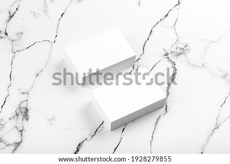 Photo of white business cards on white marble. Template for branding identity isolated on marble background. Marble premium luxury mock-up. Business Card isolated on marble stone. 
