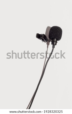 Lavalier wired microphone with clothespin vertical isolate on white background