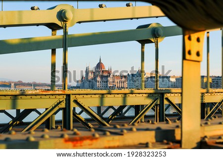The Hungarian Parlilament's buiding framed with the Szechenyi Chain  bridge. The bridge conditions is poor but renovation works begin in 2021. Famous tourist attraction Royalty-Free Stock Photo #1928323253